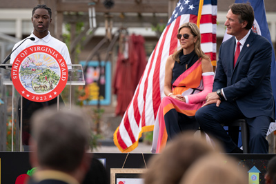 Spirit4-Event-photo1 student at podium while Governor and First Lady listens