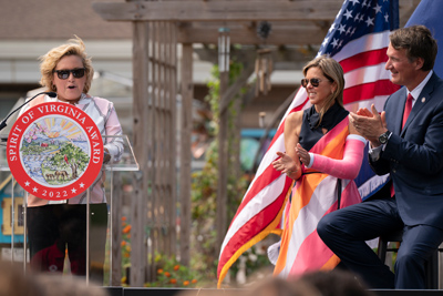 Spirit4-Event-photo1 student at podium while Governor and First Lady listens