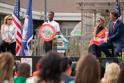 Spirit4-Event-photo1 student at podium while Governor and First Lady listens