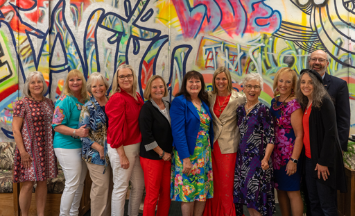First Lady with ladies in front of graffiti art wall